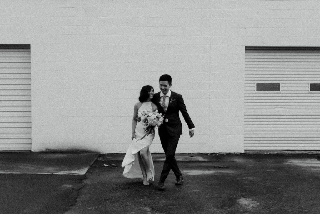 A couple playfully taking wedding photos at Factory Atlanta.